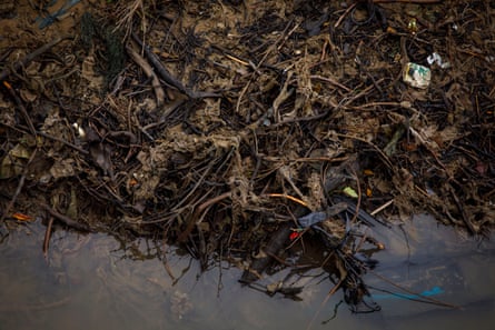 Rubbish and debris along the riverbank.