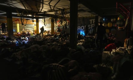 People prepare for the night in an improvised bomb shelter in a sports centre in Mariupol, 27 February.