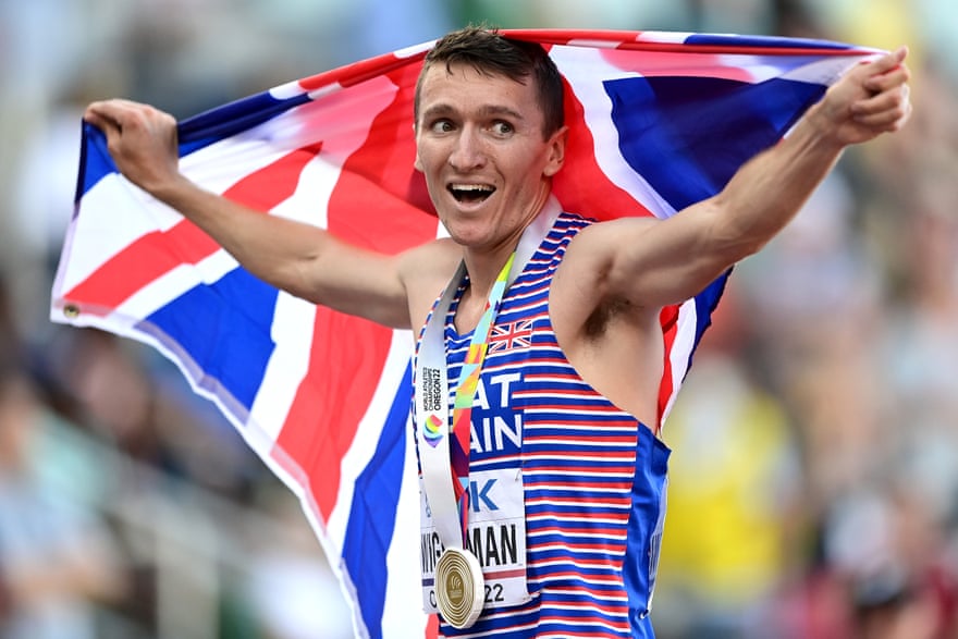 Jake Wightman celeb rates with the union jack after running the race of his life.