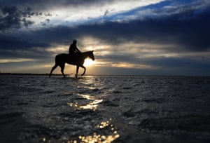 Ben Cadden riding Winx in the shallow waters of Altona beach