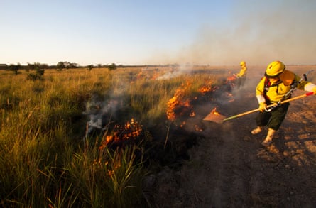 firefighters trying to beat out fires in Bolivia’s grasslands.
