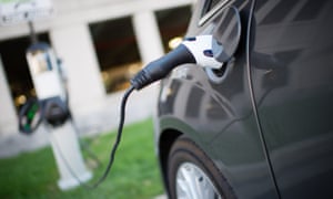 Electric cars are parked at a charging station.