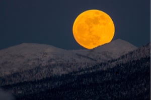 The moon seen over hills near the city of Yuzhno-Sakhalinsk on Sakhalin Island, Russia