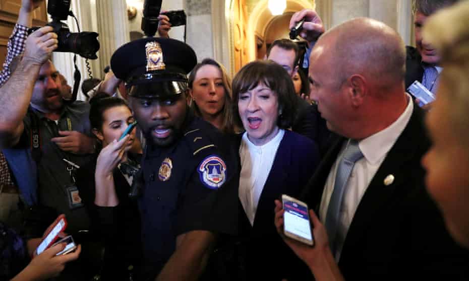 Senator Susan Collins, center, is surrounded by police and reporters as she leaves the Senate floor after Senate voted to confirm supreme court nominee Brett Kavanaugh on 6 October 2018.