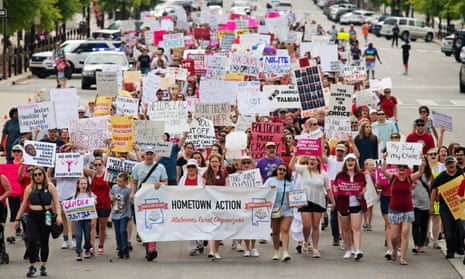 People walk to the Alabama state capitol during the March for Reproductive Freedom against the state’s new abortion law, in Montgomery, Alabama, on 19 May.