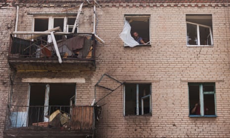 A Ukrainian man checks damage in houses following recent Russian shelling in the city of Slovyansk.