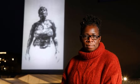 Rosamund Kissi-Debrah, whose daughter Ella died from air pollution 10 years ago, viewing an artwork projection at London’s South Bank – Breathe For Ella by Dryden Goodwin.
