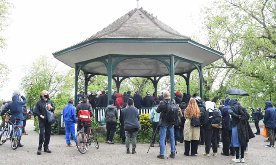 People gather at a bandstand for a vigil for BLM activist Sasha Johnson in Camberwell, south-east London.
