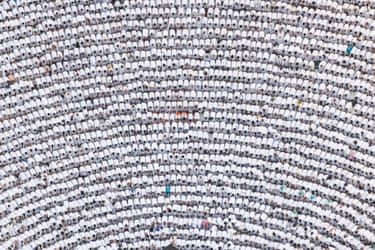 Aerial view of a large crowd of pilgrims in white robes at prayer