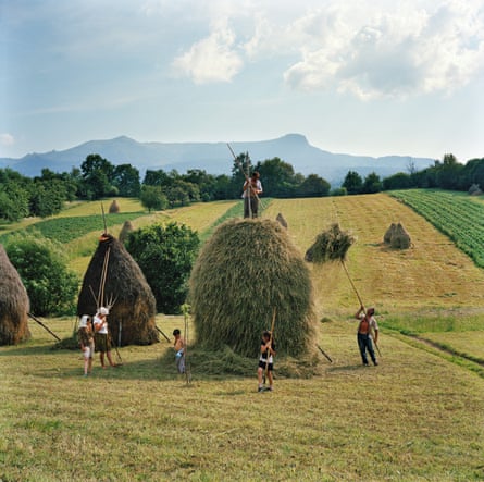 The whole Borca family, from Breb, puts finishing touches on one of the 40 haystacks it makes each summer in Maramureș, Romania, 2012.
