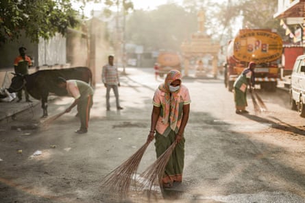 Workers clean the area outside a polling station a day prior to the second phase of India’s general election, in Bengaluru, Karnataka, April 25, 2024.