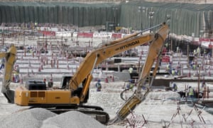Workers at the Al-Wakrah stadium in Doha use heavy machinery during preparations for the 2022 World Cup in Qatar