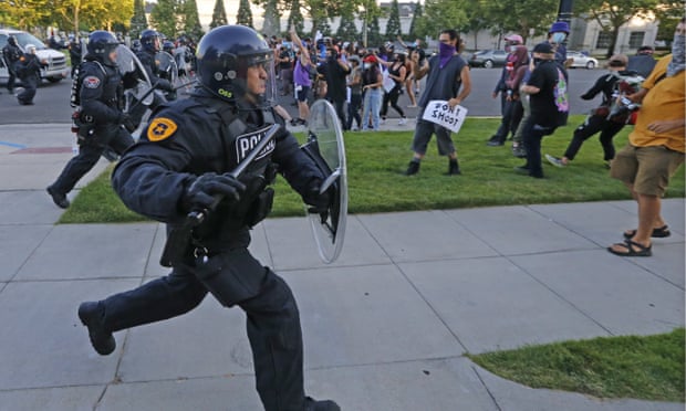 A Salt Lake City police officer at a protest earlier in July. Police foundations – which provide funds to local police departments – in cities such as Salt Lake are partially funded by corporate names.