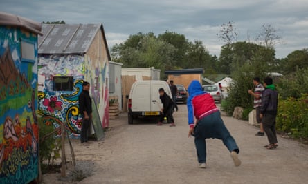 Young refugees in the Calais camp play cricket