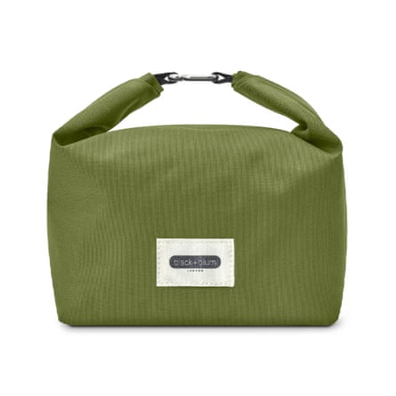 A ribbed green bag with a short handle that has a metal clasp in the middle