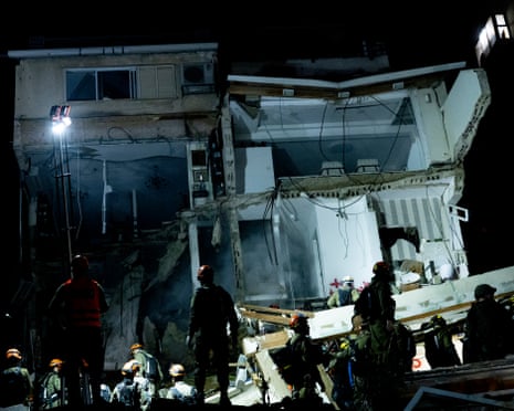 Israeli emergency responders searching for missing people on Sunday night at the strike scene in Haif