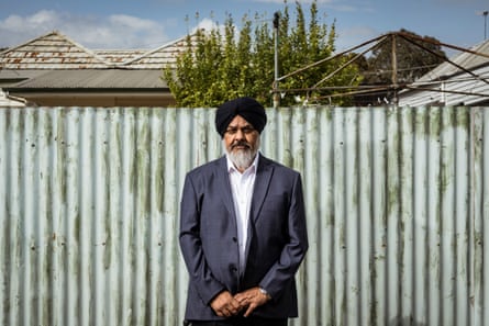 Onkar Singh stands by a fence