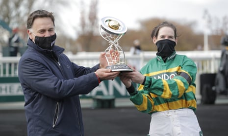 Rachael Blackmore and Trainer Henry De Bromhead celebrate with the trophy after riding Minella Times to victory.