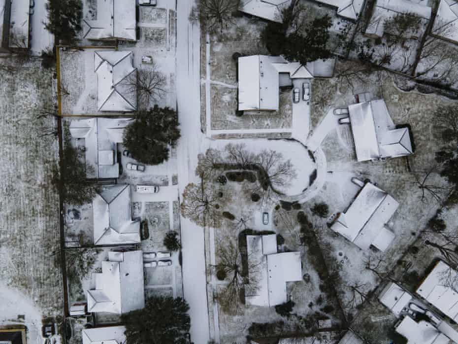 Homes in the Westbury neighborhood are covered in snow in Houston, 15 February 2021.