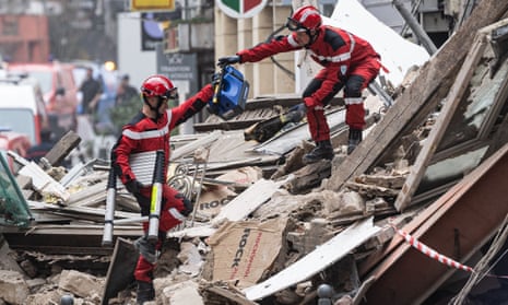 Firefighters search the collapsed buildings in Lille