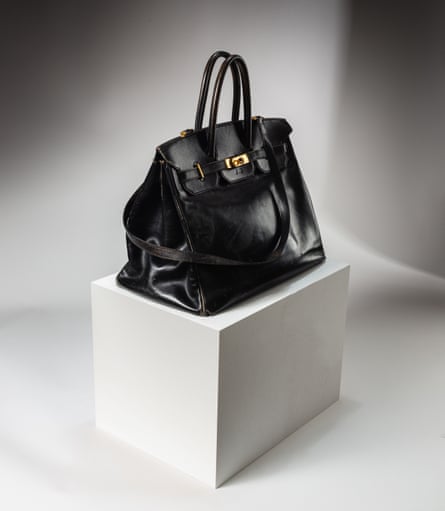 The original Birkin Bag on display on a white plinth