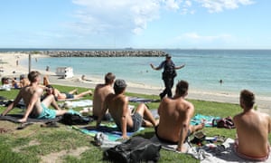 WA police officers encourage beach goers to practice social distancing in Perth. Scott Morrison announced a tightening of Australia’s coronavirus rules and restrictions and limited gatherings to a maximum of two people.