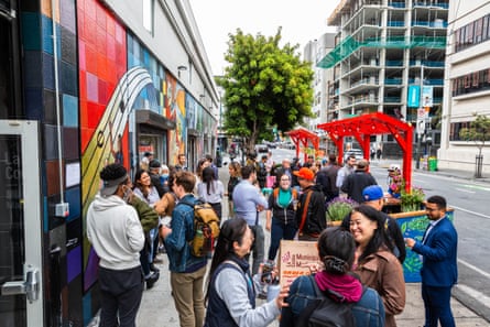people gather on sidewalk outside la cocina