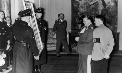 Nazi Field-Marshal Hermann Goering admires a painting given to him by Adolf Hitler, right, for his 45th birthday, 1938.