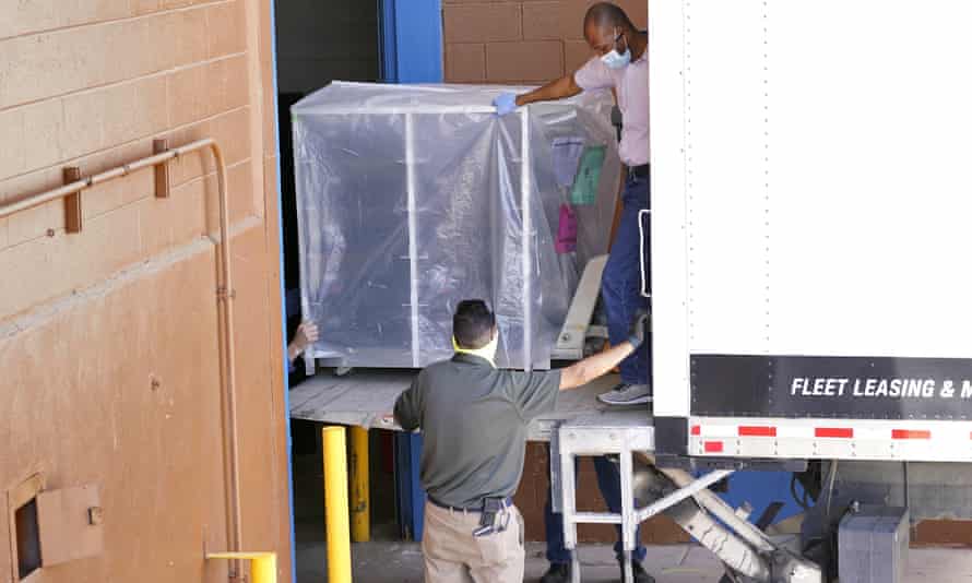 Officials unload the electoral equipment.