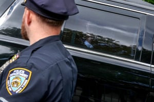 Former US president Donald Trump waves from his vehicle as his motorcade arrives at Manhattan criminal court on Thursday.
