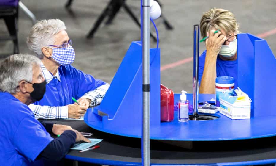 Contractors working for Cyber Ninjas, who was hired by the Arizona state senate, examine and recount ballots in Phoenix on 1 May.