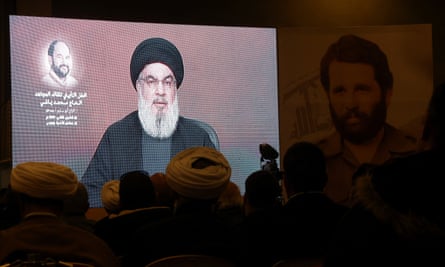 Nasrallah on screen during his televised address.