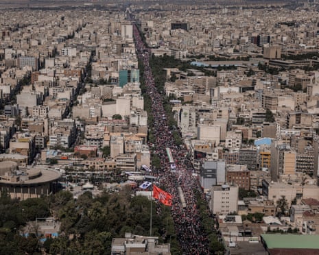 Aerial view of mourners lining a main thoroughfare in Tehran during the funeral procession for Ali Khamenei.