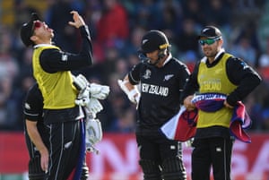 12th man Tim Southee calls for some throat spray for batsman Kane Williamson.