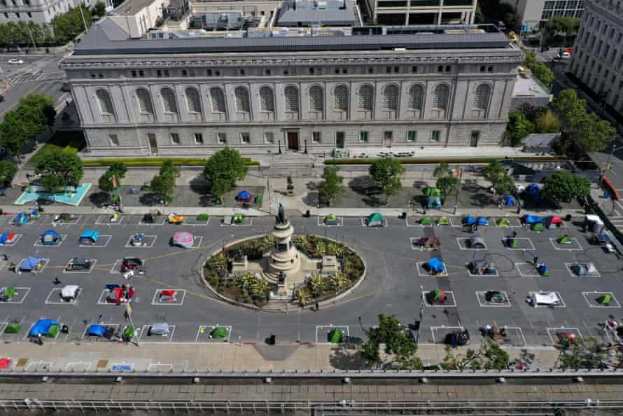 San Francisco’s first sanctioned tent encampment is in a fenced-off space near city hall with spaces marked for social distancing and some amenities.