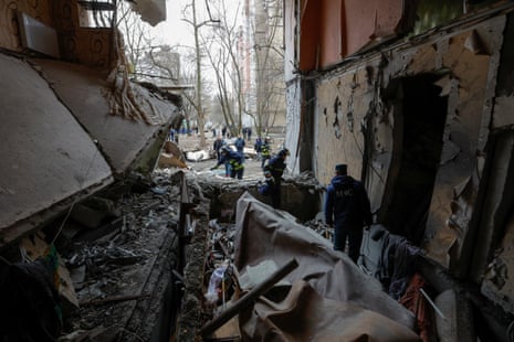 Members of a local emergencies ministry take part in a search-and-rescue operation in a multistorey apartment block damaged in recent shelling in Donetsk.