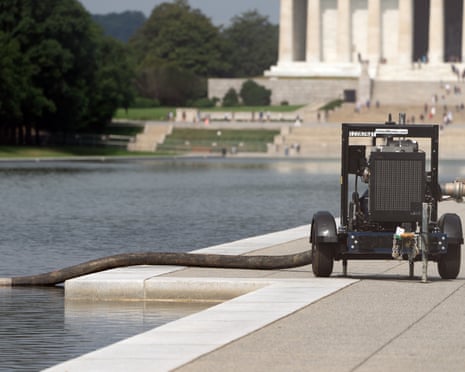 A pump, connected to a hose, is placed next to the Lincoln Memorial Reflecting Pool.