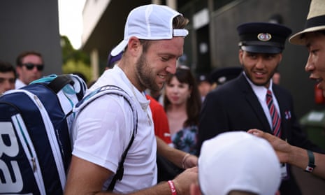 US player Jack Sock signs autographs after winning his men’s singles first round match against Chile’s Christian Garin.