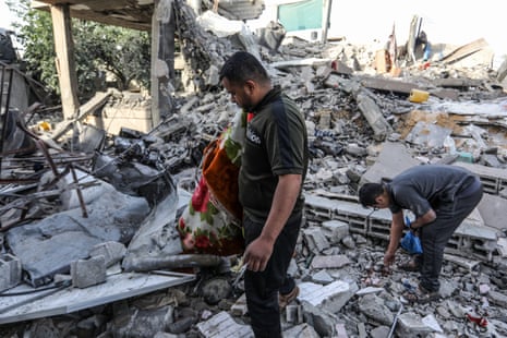 Palestinians residents living in the area inspect demolished buildings after Israeli attacks in Rafah.