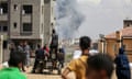 People watch smoke rising in the distance after an Israeli strike on Rafah on Monday.