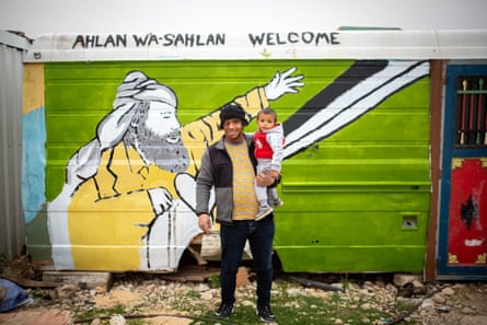 Awdah and his son in front of a mural in Umm il Khair that was painted to memorialize Haj Suleiman, Awdah’s uncle, who was killed by the Israeli police, March 2022.