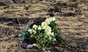 Flowers laid during a memorial service for victims at the crash site of Ethiopian Airlines flight ET302 in Bishoftu