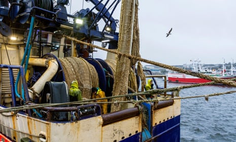 Fishers work on their nets in Killybegs, County Donegal. Boat owners say they do not condone ill-treatment of workers.