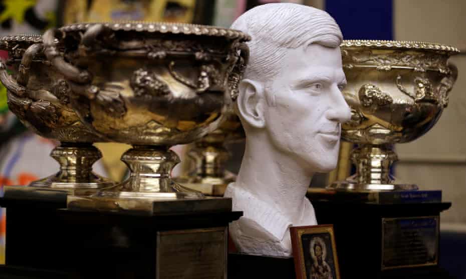 A bust of Novak Djokovic is surrounded with Australian Open trophies in Belgrade