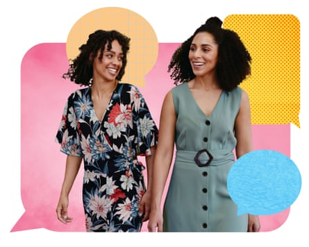 Two women in party attire stand next to each other smiling