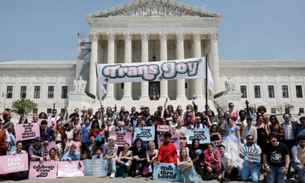 People in front of a banner that reads ‘trans joy’ outside the US supreme court building 