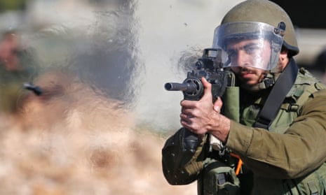 An Israeli soldier fires a rubber bullet.