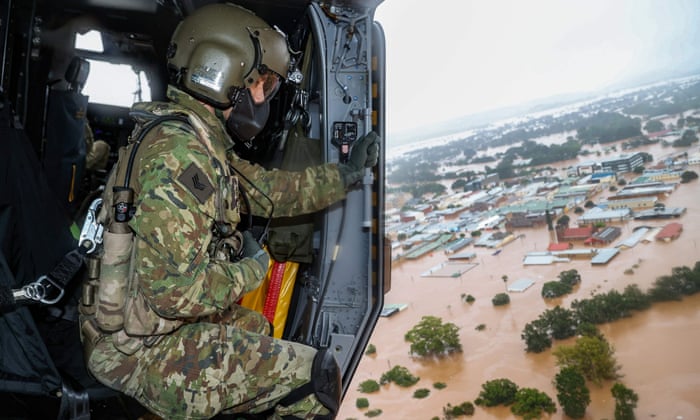 Australian army aircrewman Sergeant Rick Scott surveys flood waters over Lismore in February.