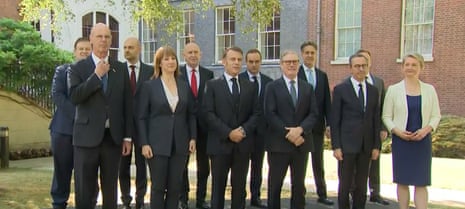 Keir Starmer and Emmanuel Macron, with their ministers, posing for picture at start of UK-France summit