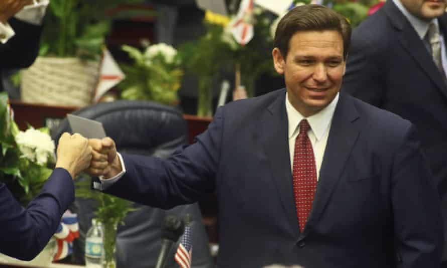 DeSantis fist bumps a legislator in Tallahassee on 2 March.
